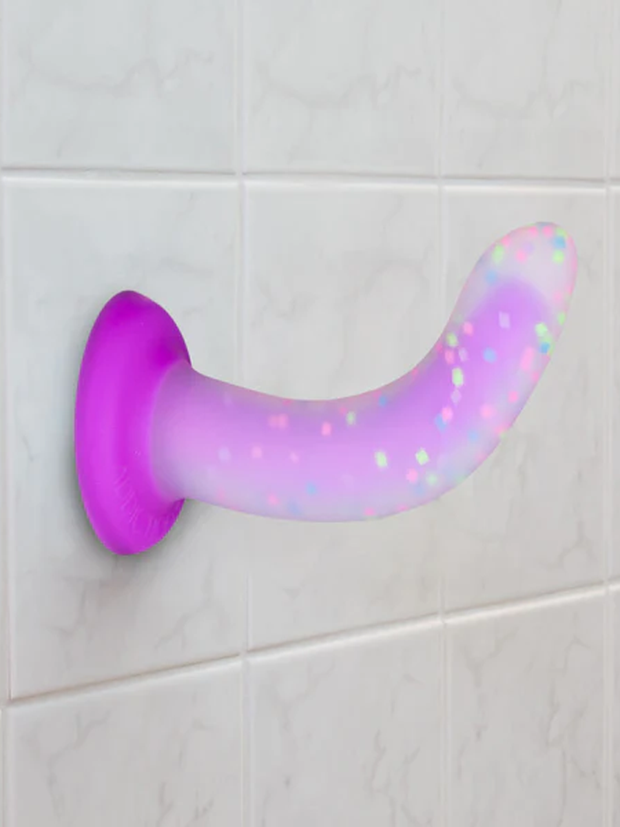 Rave Posable Dildo suction cupped to a tile wall